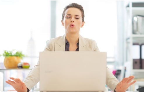 Managing stress and building resilience from the Welbee learning centre. Accept your stressors - picture of a woman in front of laptop  breathing and meditating.