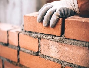 Resilience and wellbeing toolkit from the Welbee Learning Centre. A picture of a brick wall. Like resilience it takes time to build.