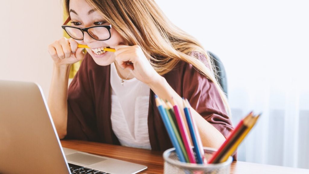 Communicating remotely and how to do it effectively from the Welbee Learning Centre. A picture of a teacher looking anxious on a video call.