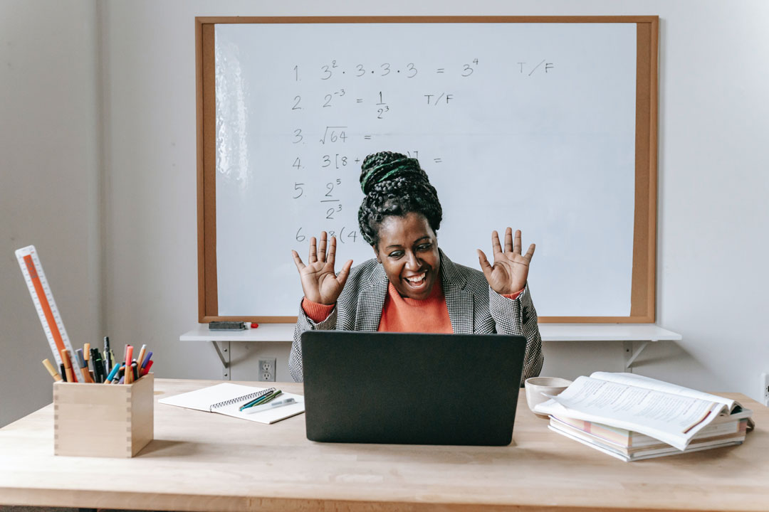 Happy teacher in front of wipe board