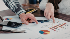 School leaders analysing printed data on an office desk.